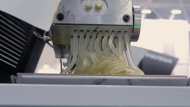 Waste plastic recycling machine: process of melting polyethylene at plant, factory - close up view. Environmental protection, industrial, automated technology concept