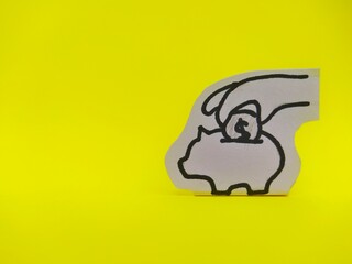 Saving coins in the piggy bank paper cut Isolated on yellow background