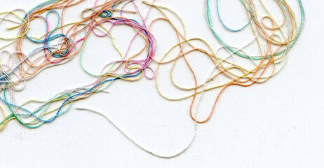 Multicolor tangled color needlecraft silk cord. Abstract color background, in white background