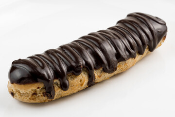 Dessert Bomba de Chocolate. Brazilian traditional éclair on a white background. Close-up macro. Selective focus.