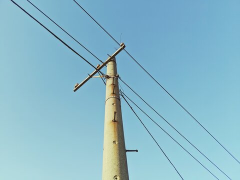 Low Angle View Of Electricity Pylon Against Clear Sky