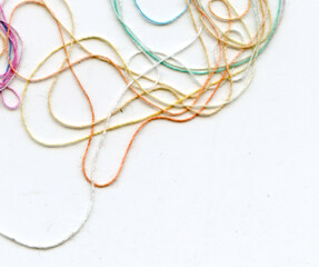 Multicolor tangled color needlecraft silk cord. Abstract color background, in white background