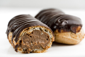 Dessert Bomba de Chocolate. Brazilian traditional éclair on a white background. Close-up macro. Selective focus.
