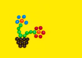 Candy flowers from coloured candies flowerpot. Colorful holiday sweets with bright copy space for text. Spring concept.