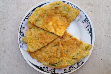Telur dadar or omelette is one of the favorite and cheap side dishes in Indonesia. Simple omelette with egg mixture, shallots, scallions, and a pinch of pepper and salt.