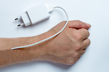 A charger implanted in the human hand. Need to recharge, exhaustion, burst of energy.