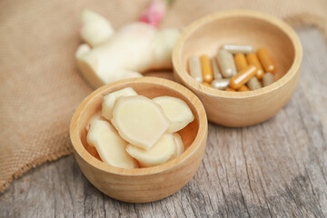 Fototapeta na wymiar Herbal medicine capsule from organic ginger for health care eating in daily life