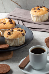 Muffins served with coffee, chocolate bar and cookies. Breakfast food.