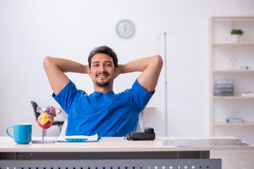 Young male doctor cardiologist working in the clinic