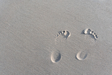 footprints of a man on white sand, at sea. High quality photo