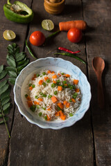Vegetable pulao or flavoured rice mix with vegetables served in a bowl. Top view.