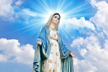 Statue of Our lady of grace virgin Mary with Bright Blue Sky and beautiful clouds with abstract...