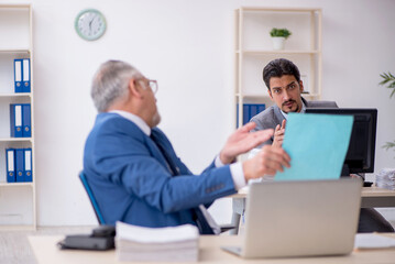 Two male colleagues working in the office