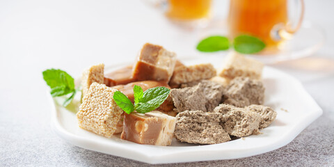 Oriental sweetness.  Nougat, halva and  tea on a table.
