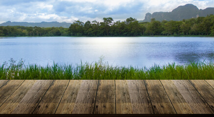 beautiful wood floor and natural river, grassland and mountain background