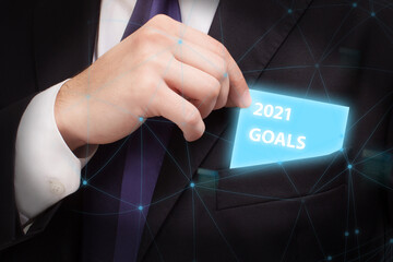 Business, technology, internet and network concept. Young businessman thinks over the steps for successful growth: 2021 goals