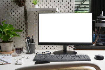 Mock up computer with white screen on office desk.