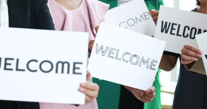 Group of people joins together greeting and hold welcome words for a sign of happiness and pleasure for coming of something or someone.