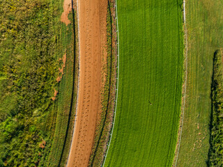 Aerial view of rural racetrack for racehorses empty in early morning light