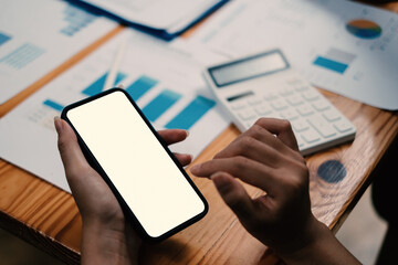 Asian woman showing smartphone with blank screen at cafe. Blank screen for your advertising.