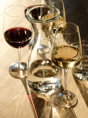 Pizza and drinks - wine and cocktail in natural sunlight on wooden table in restaurant interior background for friends holiday party time. Traditional Italian bread and cuisine recipe