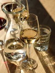 Pizza and drinks - wine and cocktail in natural sunlight on wooden table in restaurant interior background for friends holiday party time. Traditional Italian bread and cuisine recipe