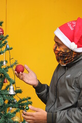 Impressed Young Man  wear Bikers face mask and thoughting at christmas ball