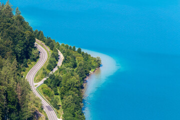 Aerial view to lake attersee peninsula shore edge with trees and beach. Austria, salzburg