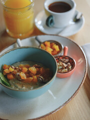 Heathy breakfast with oatmeal and diet fruits, berries and nuts, Home heathy food concept with natural sun light