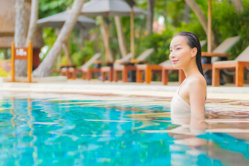Portrait beautiful young asian woman relax around outdoor swimming pool