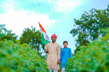 young indian farmer and his child with indian flag