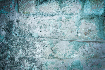 old brick wall. cracked concrete. Green tide, blue texture. vintage background. rustic style, mold.