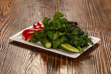 Fresh vegetables plate with vegetables and herbs