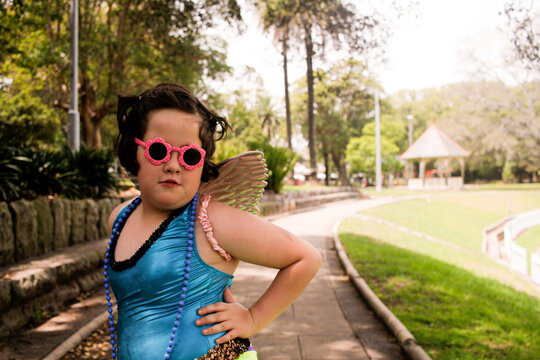 Young girl wearing bright blue leotard top posing for the camera