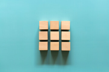 Empty wooden cube on blue background. Top view. Business concept - obrazy, fototapety, plakaty