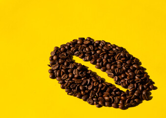 Coffee beans in the shape of a bean with a yellow background