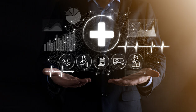Businessman hold virtual plus medical network connection icons. Covid-19 pandemic develop people awareness and spread attention on their healthcare.Doctor,document,medicine,ambulance,patient icon.