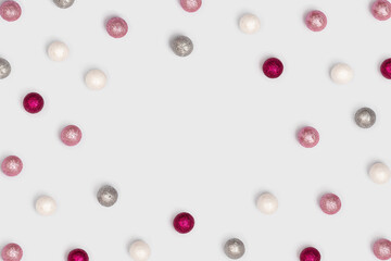 Bright holiday frame with sparkling balls on white background with copy space. Birthday or anniversary celebration concept