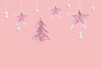 Merry Christmas and Happy New Year pink background with copy space. Hanging pink star and Christmas...