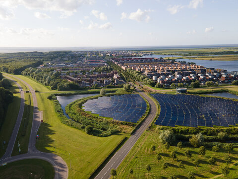 Modern innovative residential area in Almere, along the waterside, including solar panel field. The Netherlands, Flevoland.