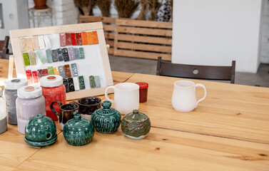 Handmade Ceramic Pottery. White, not painted clay pottery standing on table. Creative studio potter.