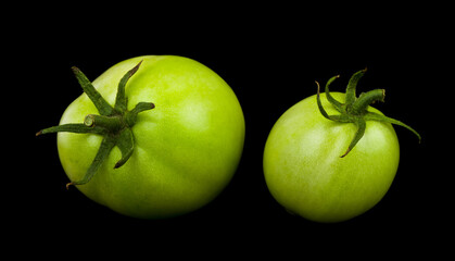 Green tomatoes isolated on black background. Healthy food.