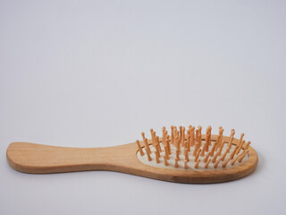 Single wooden massage brush, comb isolated on white background