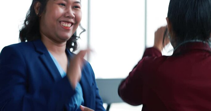Back view of businesswoman walking into office and colleagues clapping hand ovation to her. Idea for good teamwork feeling declaration and support from friends in company.