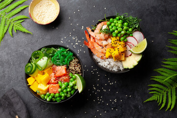 Poke bowls with shrimps, salmon, avocado and mango