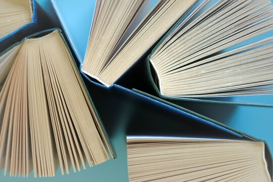 Books on a blue background.Reading of books.Knowledge and Learning Concept.Knowledge and education.Book pages close-up.Reading concept. High quality photo