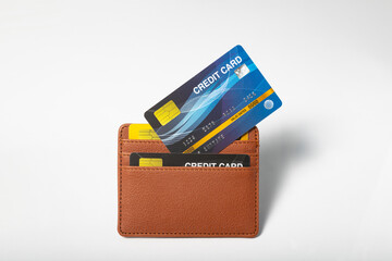 Credit cards in leather wallet on white background - obrazy, fototapety, plakaty