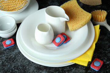 Concept of Dishwashing detergent accessories on black smokey table