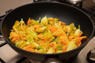 Courgette flowers in a pan