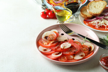 Concept of tasty food with tomato carpaccio on white textured table